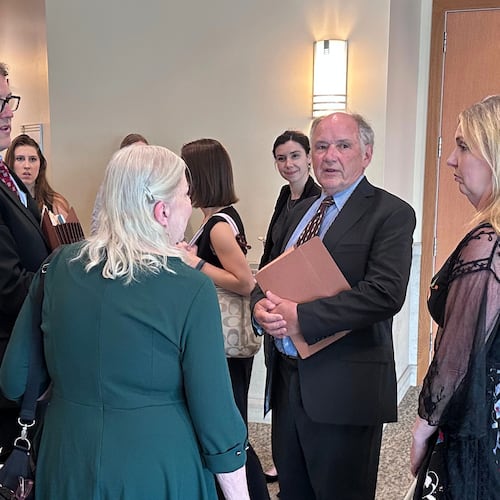 Jim Troupis, former campaign attorney for President Donald Trump, second from right, speaks with a group including his attorney Joe Bugni, left, after pleading not guilty to several felony forgery counts related to the 2020 fake elector scheme Tuesday, June 16, 2026, in Madison, Wis. (AP Photo/Scott Bauer)