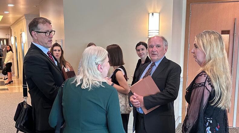 Jim Troupis, former campaign attorney for President Donald Trump, second from right, speaks with a group including his attorney Joe Bugni, left, after pleading not guilty to several felony forgery counts related to the 2020 fake elector scheme Tuesday, June 16, 2026, in Madison, Wis. (AP Photo/Scott Bauer)
