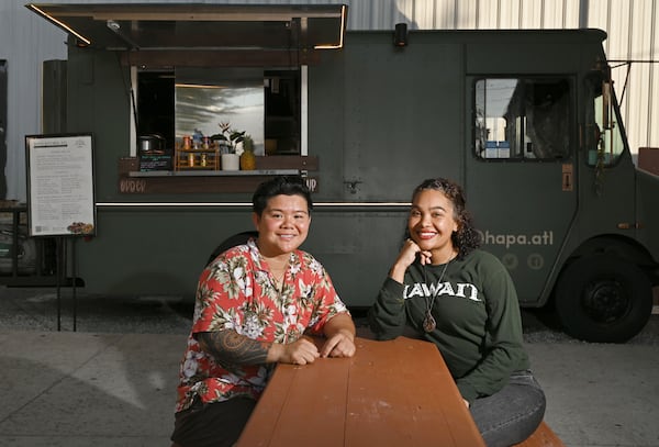 Sara Siv (left) and Jess Gorsuch sit in front of their food truck before the dinner rush at Block & Drum in Chamblee on Wednesday, June 17, 2026. (Hyosub Shin/AJC)