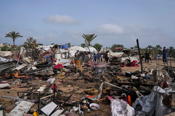 Palestinians inspect the site destroyed by Israeli airstrikes in Khan Younis, Gaza Strip, Sunday, May 18, 2025. (AP Photo/Abdel Kareem Hana)