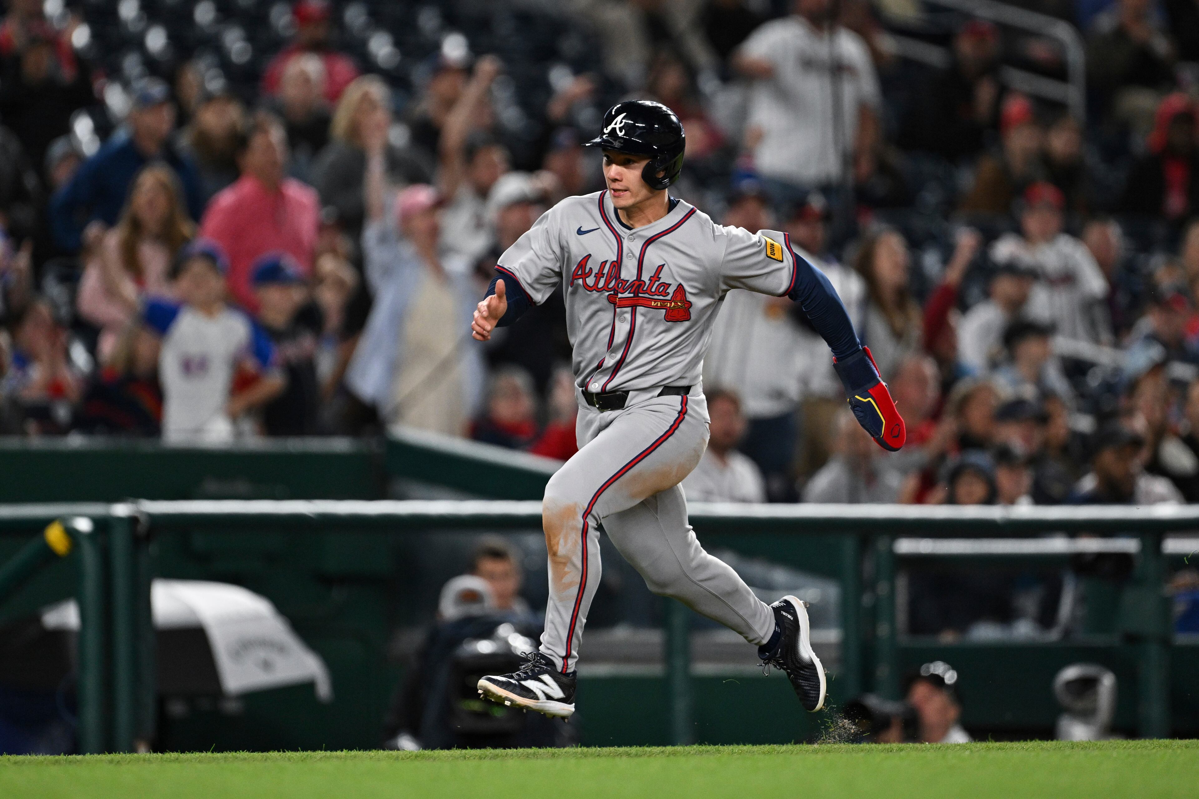Atlanta Braves' Stuart Fairchild scores a run on single hit by Marcell Ozuna against Washington Nationals pitcher Jose A. Ferrer during the seventh inning of a baseball game in Washington, Thursday, May 22, 2025. (AP Photo/Terrance Williams)