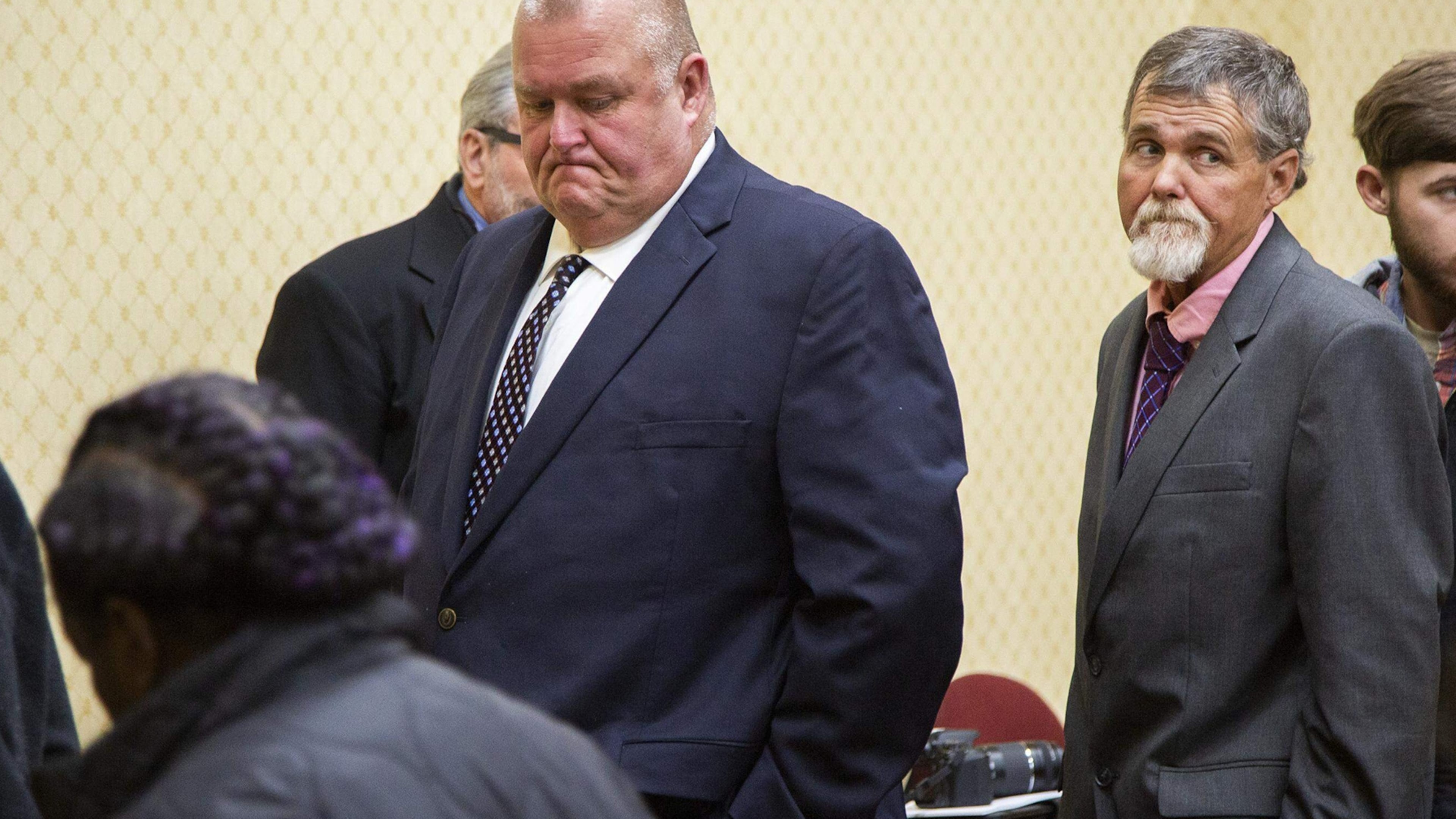 Former Washington County Deputies Michael Howell, left and Henry Copeland, right, leave the court room in Washington County after a delay in their retrial on murder charges stemming from the 2017 death of Eurie Martin. Not pictured is third defendant Rhett Scott. (Grant Blankenship/GPB)