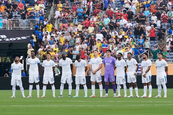 Players of the two teams observe a minute of silence in memory of Portugal international and Liverpool player Diogo Jota and his brother Andre Silva, before the Club World Cup quarterfinal soccer match between Fluminense and Al Hilal in Orlando, Fla., Friday, July 4, 2025. (AP Photo/John Raoux)