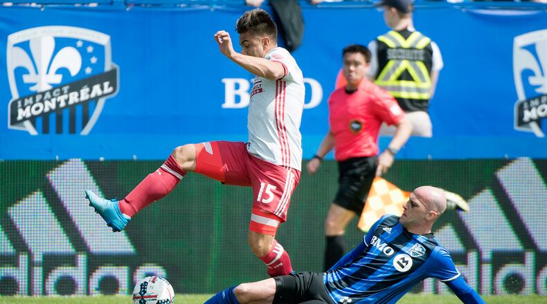 Montreal Impact’s Laurent Ciman, right, challenges Atlanta United’s Hector Villalba during first half of an MLS soccer game in Montreal, Saturday, April 15, 2017. (Graham Hughes/The Canadian Press via AP)