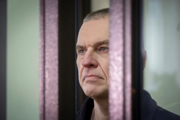 FILE - Journalist Andrzej Poczobut stands in a defendants' cage in court in Grodno, Belarus, on Jan. 16, 2023. (Leonid Shcheglov/Pool via AP, File)