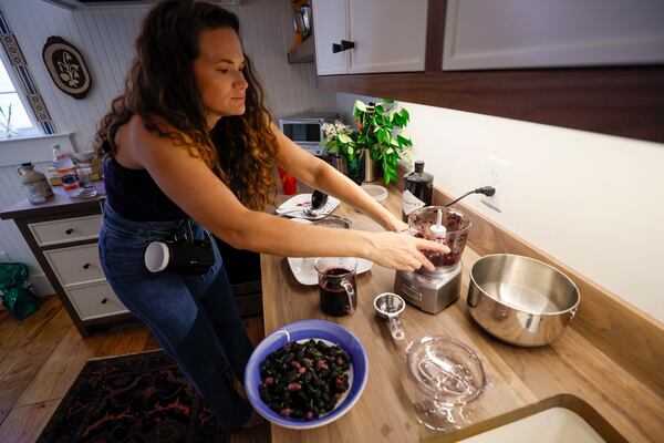 Amelia Lerner of Decatur prepares foraged mulberries for various recipes, including cocktail mixers and jam, which they share with friends and neighbors. (Miguel Martinez/AJC)