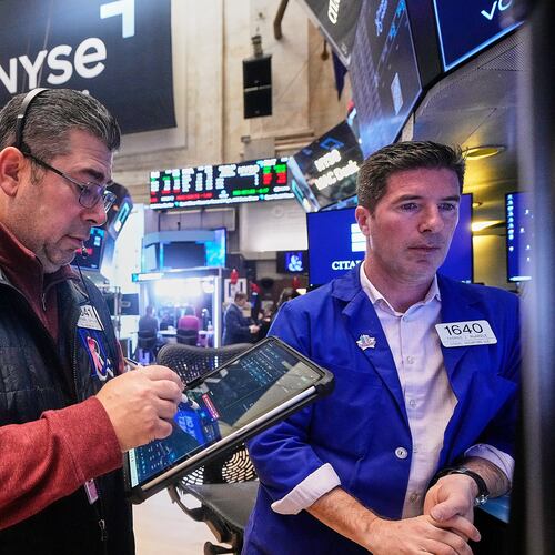 Trader Michael Capolino, left, and Specialist Thomas McArdle work on the floor of the New York Stock Exchange, Monday, Jan. 26, 2026. (AP Photo/Richard Drew)