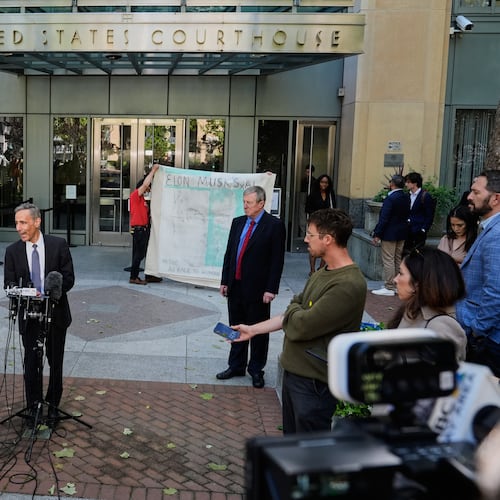 William Savitt, attorney representing OpenAI, center, speaks during a press conference outside the U.S. District Court in Oakland, Calif., Thursday, April 30, 2026. (AP Photo/Godofredo A. Vásquez)