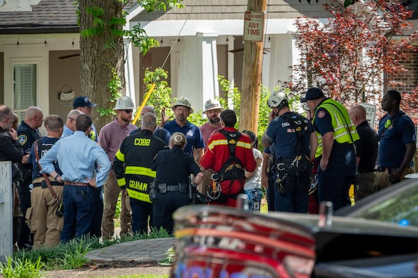 Cobb County firefighters, Acworth police officers and the local power company worked to remove a man's body after he was electrocuted Monday.