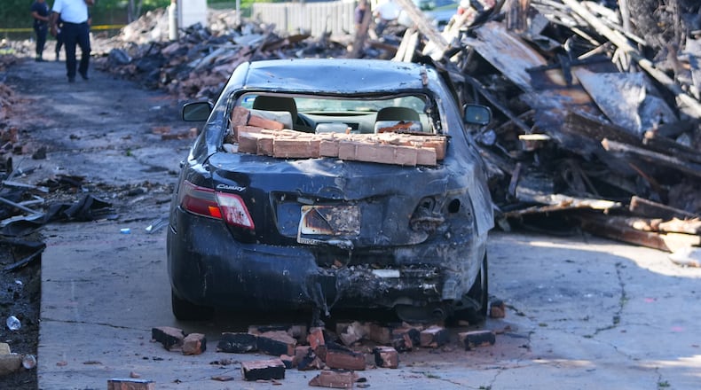 A vehicle is seen damaged following an apartment complex fire, Friday, May 29, 2026, in Dallas. (AP Photo/Julio Cortez)