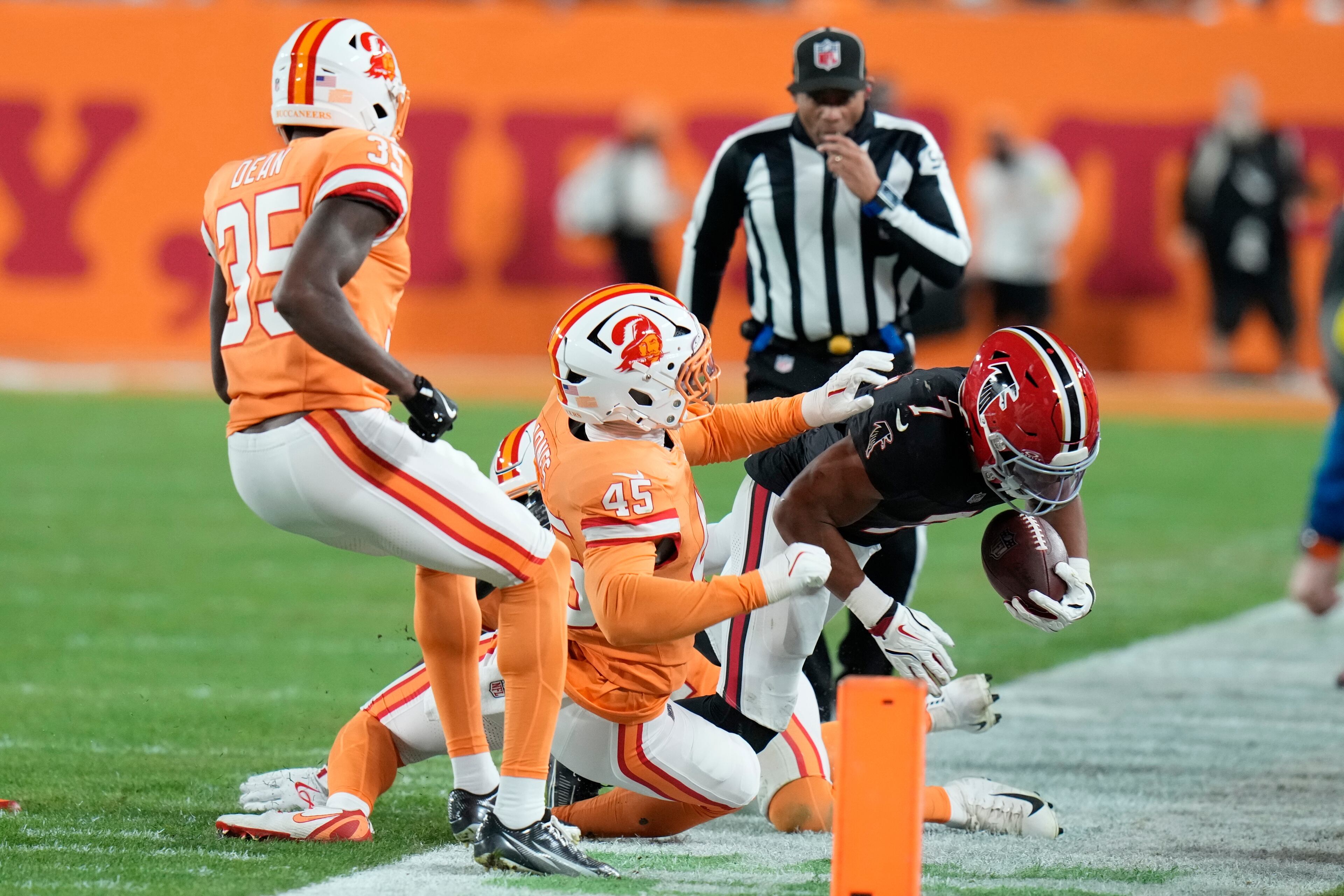 Atlanta Falcons running back Bijan Robinson (7) is pushed out by Tampa Bay Buccaneers linebacker Deion Jones (45) during the first half of an NFL football game, Thursday, Dec. 11, 2025, in Tampa, Fla. (AP Photo/Chris O'Meara)