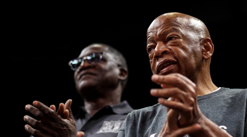 U.S. Rep. John Lewis, right, and former Atlanta Hawks player Dominique Wilkins during the pack 1 million meals event at State Farm Arena, Saturday, Oct. 5, 2019, in Atlanta. BRANDEN CAMP/SPECIAL