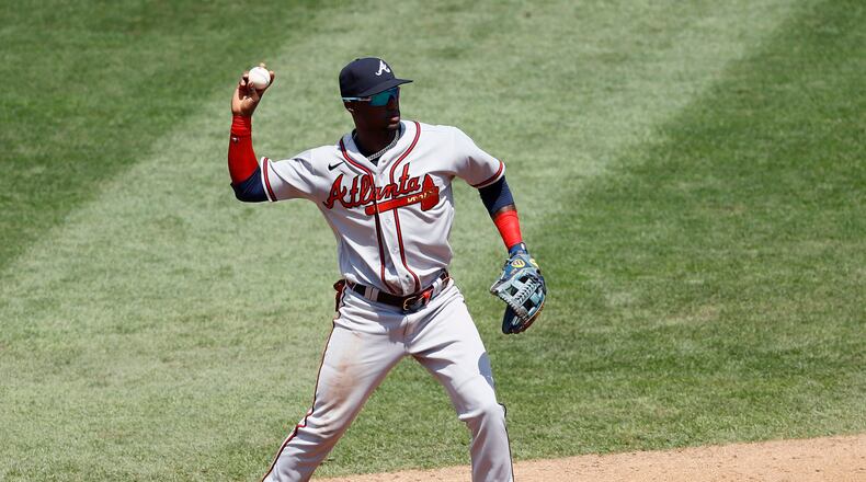 Braves second baseman Adeiny Hechavarria throws to first base after fielding a ground out by Philadelphia Phillies' Jean Segura during the second inning of the first baseball game in a doubleheader, Sunday, Aug. 9, 2020, in Philadelphia. (AP Photo/Matt Slocum)