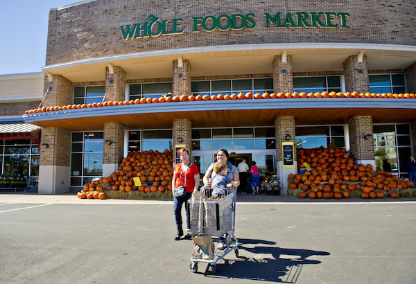 Shoppers leave a Whole Foods Market at the Avalon development in Alpharetta in 2014. Mark Toro, a real estate executive whose company developed Avalon, called Amazon’s purchase of the grocer “a validation of bricks and mortar retail.” JONATHAN PHILLIPS / SPECIAL