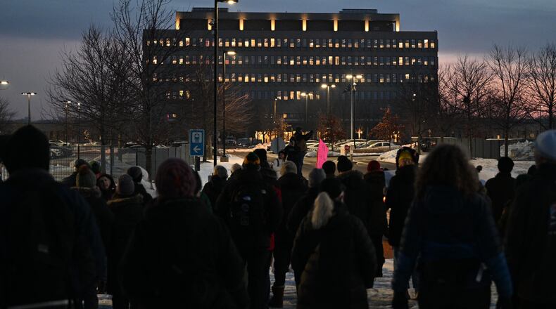 Protesters gather outside the Bishop Henry Whipple Federal Building, Thursday, Jan. 8, 2026, in Minneapolis, Minn. (AP Photo/Tom Baker)