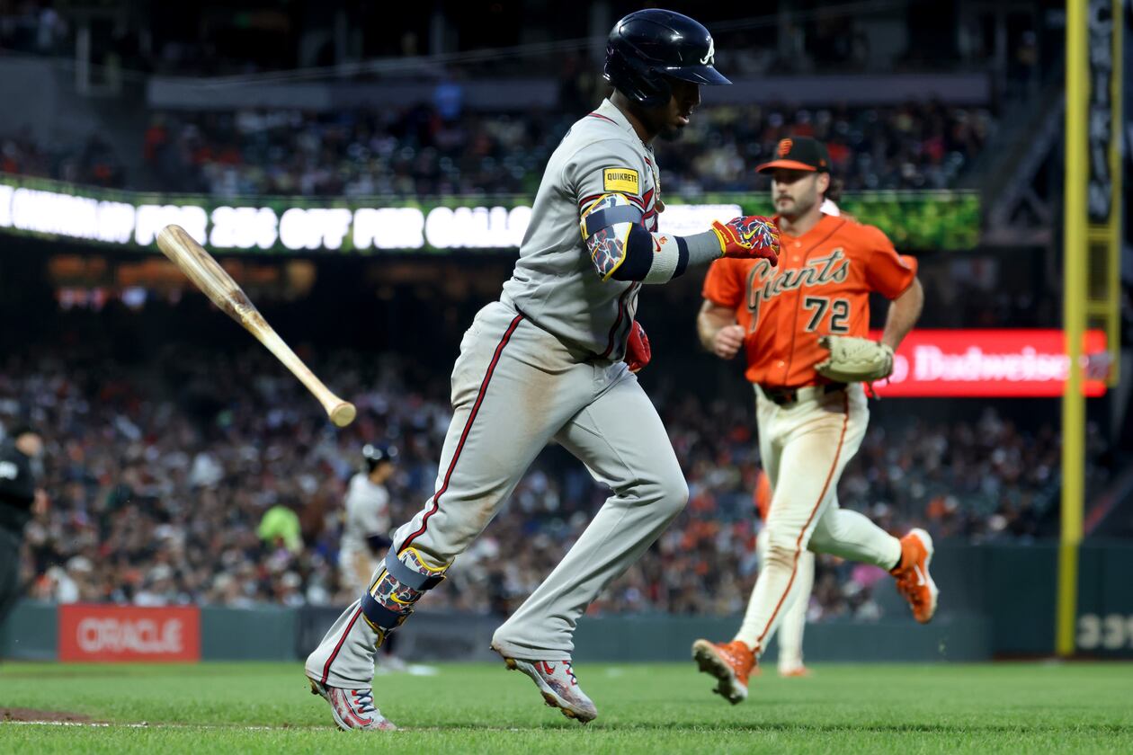 Atlanta Braves' Ozzie Albies runs to first after hitting an RBI sacrifice fly in front of San Francisco Giants pitcher Trevor McDonald on June 26, 2026. (Jed Jacobsohn/AP)