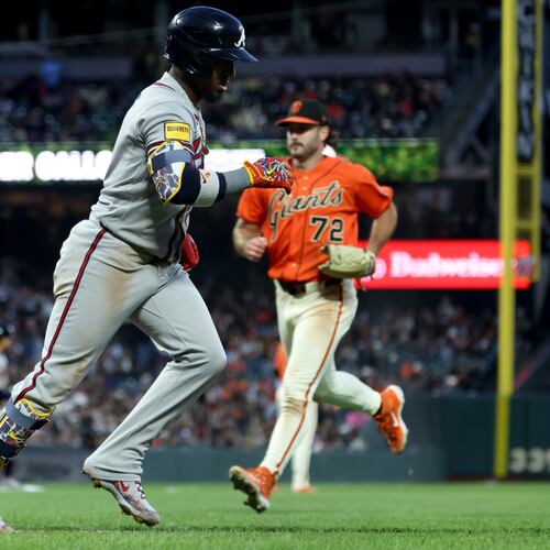 Atlanta Braves' Ozzie Albies runs to first after hitting an RBI sacrifice fly in front of San Francisco Giants pitcher Trevor McDonald on June 26, 2026. (Jed Jacobsohn/AP)