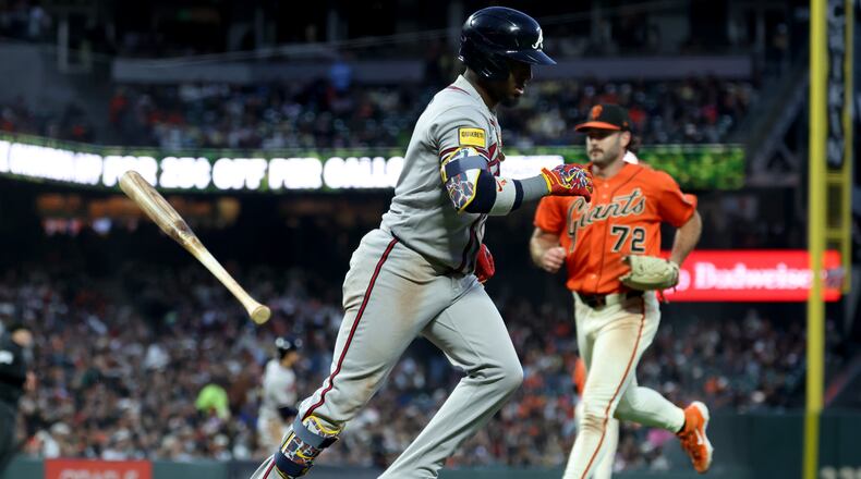 Atlanta Braves' Ozzie Albies runs to first after hitting an RBI sacrifice fly in front of San Francisco Giants pitcher Trevor McDonald on June 26, 2026. (Jed Jacobsohn/AP)