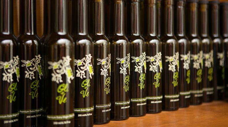 Bottles of extra virgin olive oil are showcased at Oli & Ve in Roswell.