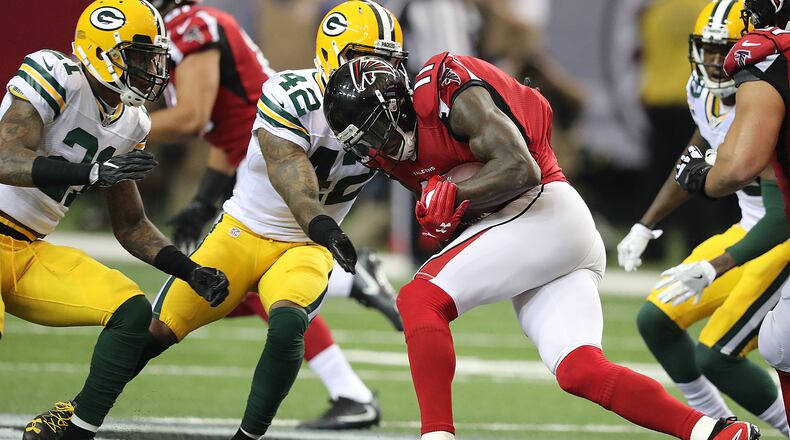 Falcons wide receiver Julio Jones makes a reception against Packers safety and former Georgia Tech star Morgan Burnett during the first half in an NFL football game on Sunday, Oct. 30, 2016, in Atlanta. Curtis Compton /ccompton@ajc.com