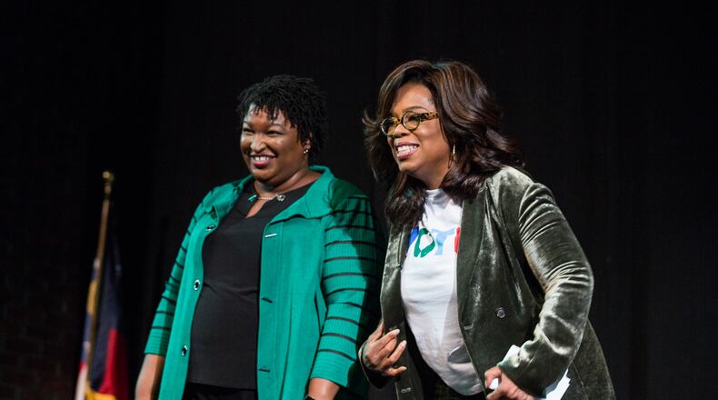 Oprah Winfrey, right, and Georgia Democratic gubernatorial candidate Stacey Abrams greet the audience during a town hall style event at the Cobb Civic Center in Marietta in November 2018. Winfrey will join up with Abrams again for a virtual campaign event Thursday.