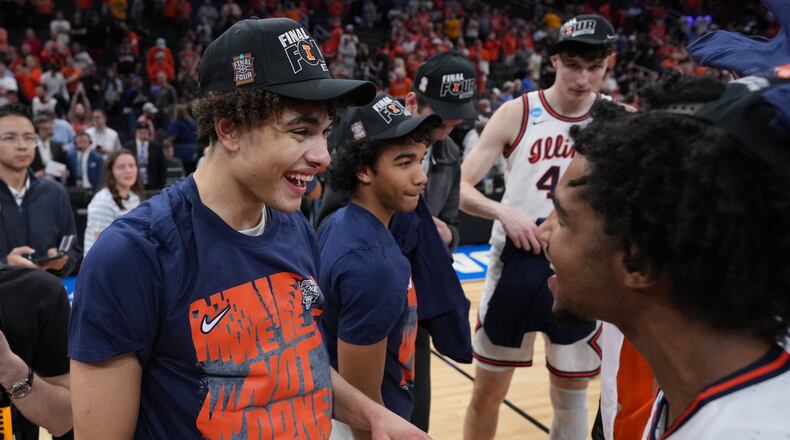 Illinois' Keaton Wagler, left, celebrates with a teammate after Illinois beat Iowa in an Elite Eight game in the NCAA college basketball tournament Saturday, March 28, 2026, in Houston. (AP Photo/Eric Gay)