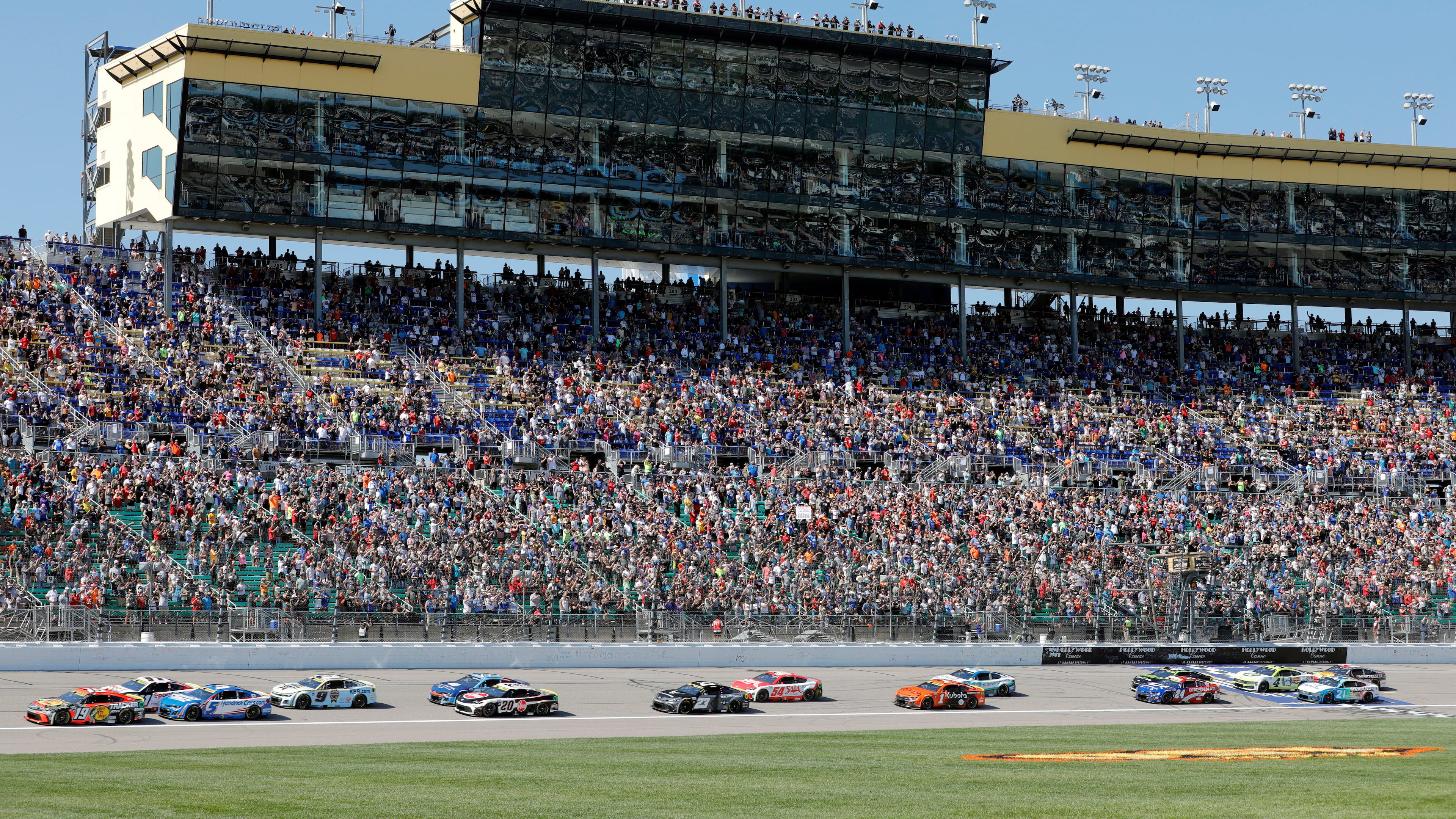 Drivers head toward Turn 1 at the start of a NASCAR Cup Series auto race at Kansas Speedway in Kansas City, Kan., Sunday, Sept. 28, 2025. (AP Photo/Colin E. Braley)