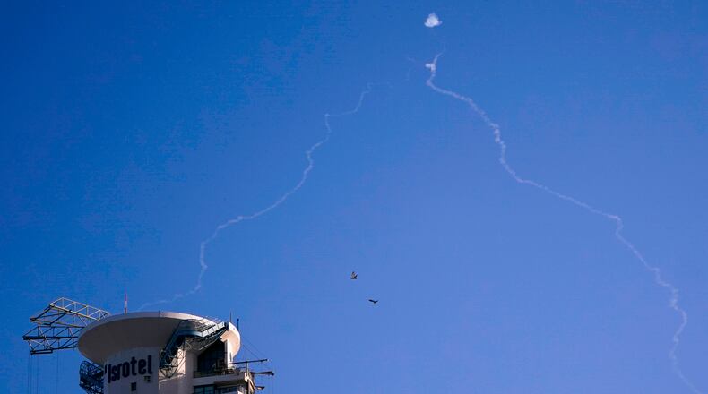 FILE - Israel's Iron Dome anti-missile system fires to intercept as air raid sirens sound in Tel Aviv, on Oct. 23, 2024. (Nathan Howard/Pool Photo via AP, File)