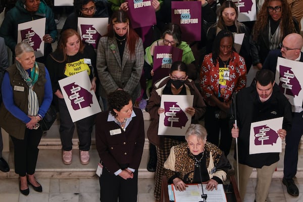 Supporters hold signs in support of legislation as Sen. Nan Orrock, D–Atlanta, speaks during a news conference at the Georgia Capitol in 2025. The legislation would ban the state funding of anti-abortion centers. (Natrice Miller/AJC)