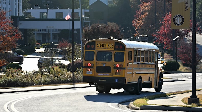 A Gwinnett school bus makes its way for drop offs on Nov. 7. (Hyosub Shin / Hyosub.Shin@ajc.com)