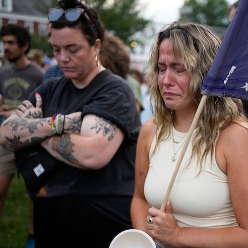 A demonstrator fights back tears at an anti-ICE rally after a man was shot and killed by U.S. Immigration and Customs Enforcement on Monday, July 13, 2026, in Biddeford, Maine. (AP Photo/Robert F. Bukaty)