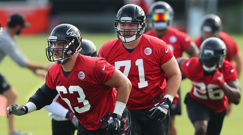 July 27, 2017 Flowery Branch: Falcons offensive guards Ben Garland (from left) and Wes Schweitzer look to block for running back Tevin Coleman on the first day of team practice at training camp on Thursday, July 27, 2017, in Flowery Branch. Curtis Compton/ccompton@ajc.com