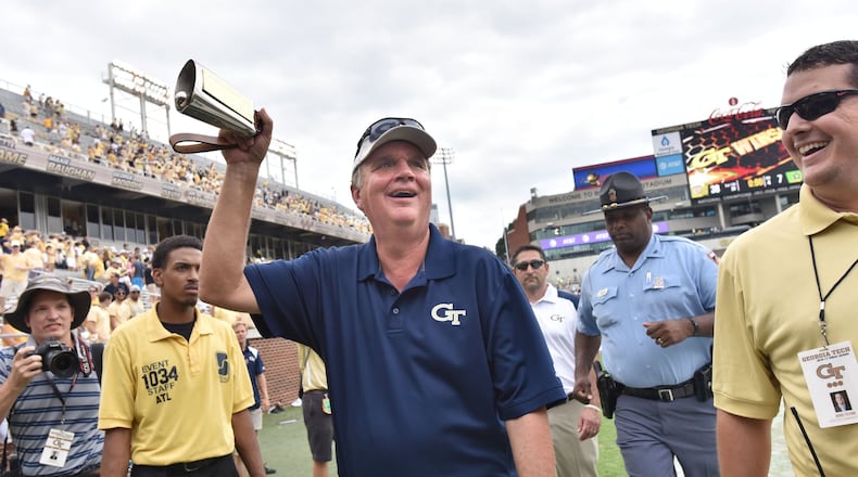 Paul Johnson rings the long-lost cowbell, marking a victory over Vanderbilt Saturday. (Hyosub Shin/hshin@ajc.com)