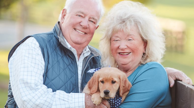 The late Joe Powell (left) with his wife, Sandy, and their dog, Lili. (Courtesy of the Powell family)