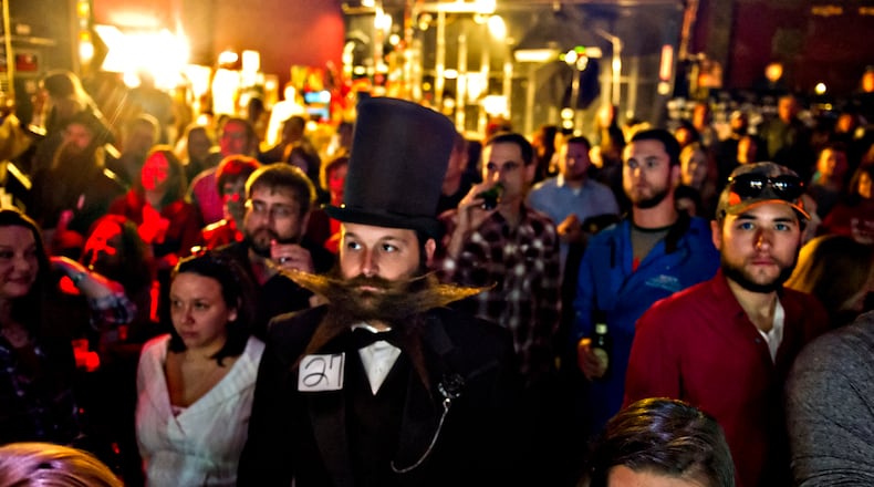 Josh Seehorn (center) waits for his turn to compete on stage during the 4th annual Battle of the Beards at Smith's Olde Bar in Atlanta on Dec. 13, 2014