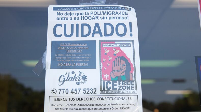 A sign is posted on the front door of La Major de Michoacan, located at 403 Atlanta Highway, in Gainesville, September 10, 2019. The sign lets guests of the ice cream shop know that Immigration and Customs Enforcement officers are not permitted inside their homes unless they have a signed warrant. (Alyssa Pointer/alyssa.pointer@ajc.com)