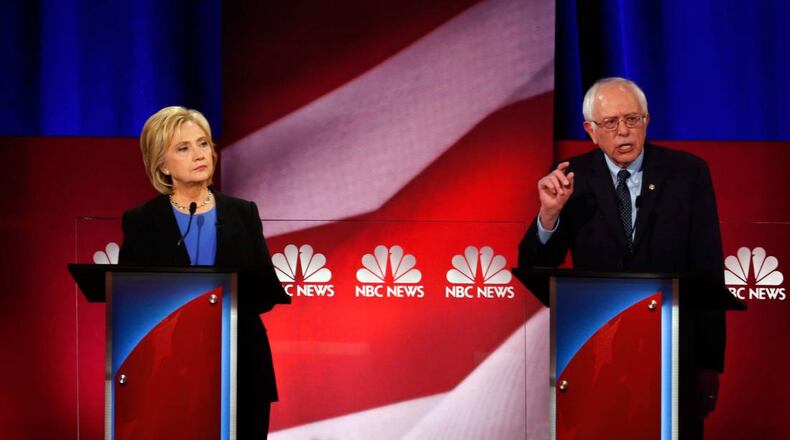 Democratic presidential candidate, Sen. Bernie Sanders, I-Vt, right, speaks, as Democratic presidential candidate, Hillary Clinton listens, at the NBC, YouTube Democratic presidential debate at the Gaillard Center, Sunday, Jan. 17, 2016, in Charleston, S.C. (AP Photo/Stephen B. Morton)