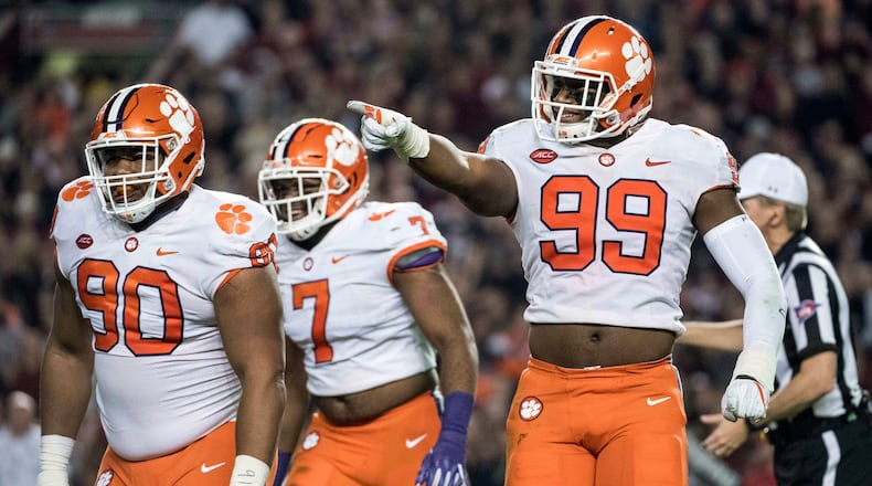 Clemson defensive end Clelin Ferrell (99), Dexter Lawrence (90) and Austin Bryant celebrate after a sack against South Carolina.
