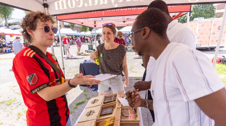 Cop City Vote Coalition volunteer Marisa Pyle (Left) helps gather referendum petition signatures before the Atlanta United game Saturday, July 15, 2023. (Steve Schaefer/steve.schaefer@ajc.com)