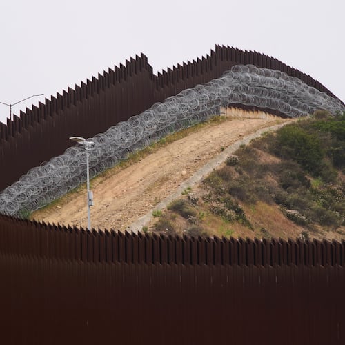 FILE - Concertina wire lines the interior of a border wall separating Tijuana, Mexico, from the United States, June 4, 2025, in San Diego. (AP Photo/Gregory Bull, File)