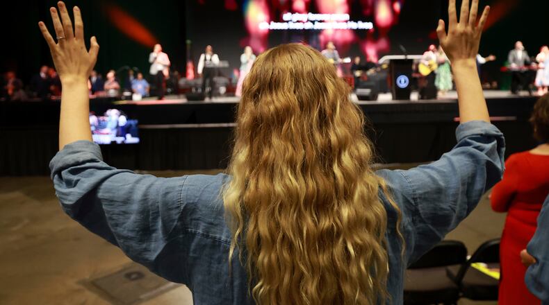FILE - A messenger attending the Southern Baptist Convention participates in worship during the 2025 SBC Annual Meeting, June 10, 2025, in Dallas. (AP Photo/Richard W. Rodriguez, file)