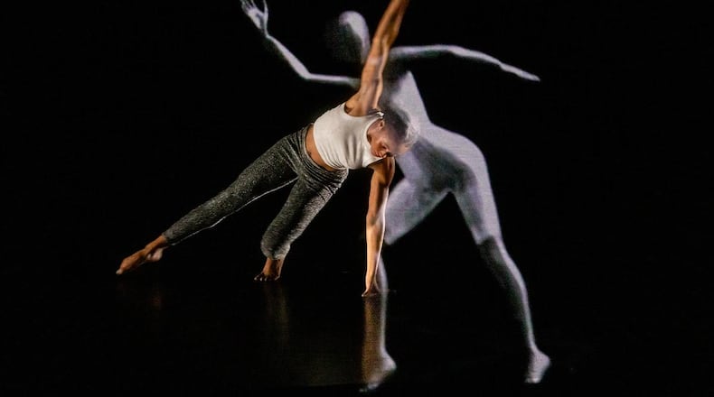 Cymone Jeter, a student in Kennesaw State University's Dance Department, with the LuminAI avatar, part of a recent performance and discussion at KSU’s Dance Theater in Marietta.