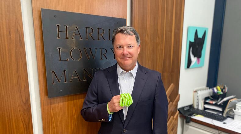 Jeff Harris, a founding partner at Harris Lowry Manton LLP, holds some of the green bracelets that Banded Together is distributing in an effort to decrease COVID-19 vaccine hesitancy. Courtesy of Banded Together