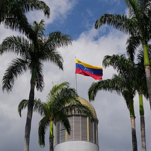 FILE - A Venezuelan flag waves in the wind atop the National Assembly palace in Caracas, Venezuela, Jan. 20, 2026. (AP Photo/Matias Delacroix, File)