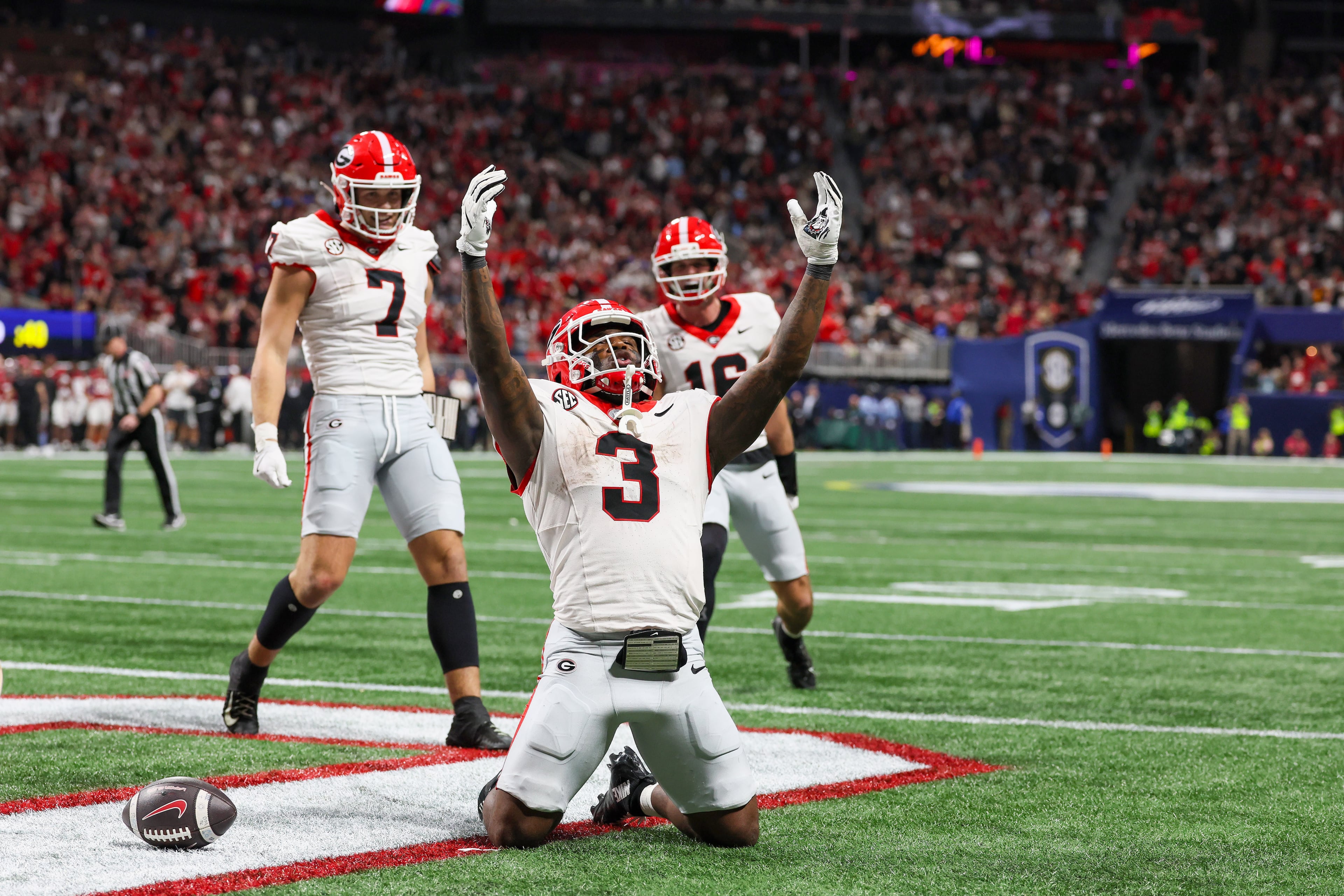 Georgia running back Nate Frazier (3) celebrates a nine yard touchdown run against Alabama with blocking help from tight end Lawson Luckie (7) and wide receiver London Humphreys (16) during the third quarter of the SEC Championship game at Mercedes-Benz Stadium, Saturday, Dec. 6, 2025, in Atlanta. (Jason Getz / AJC)