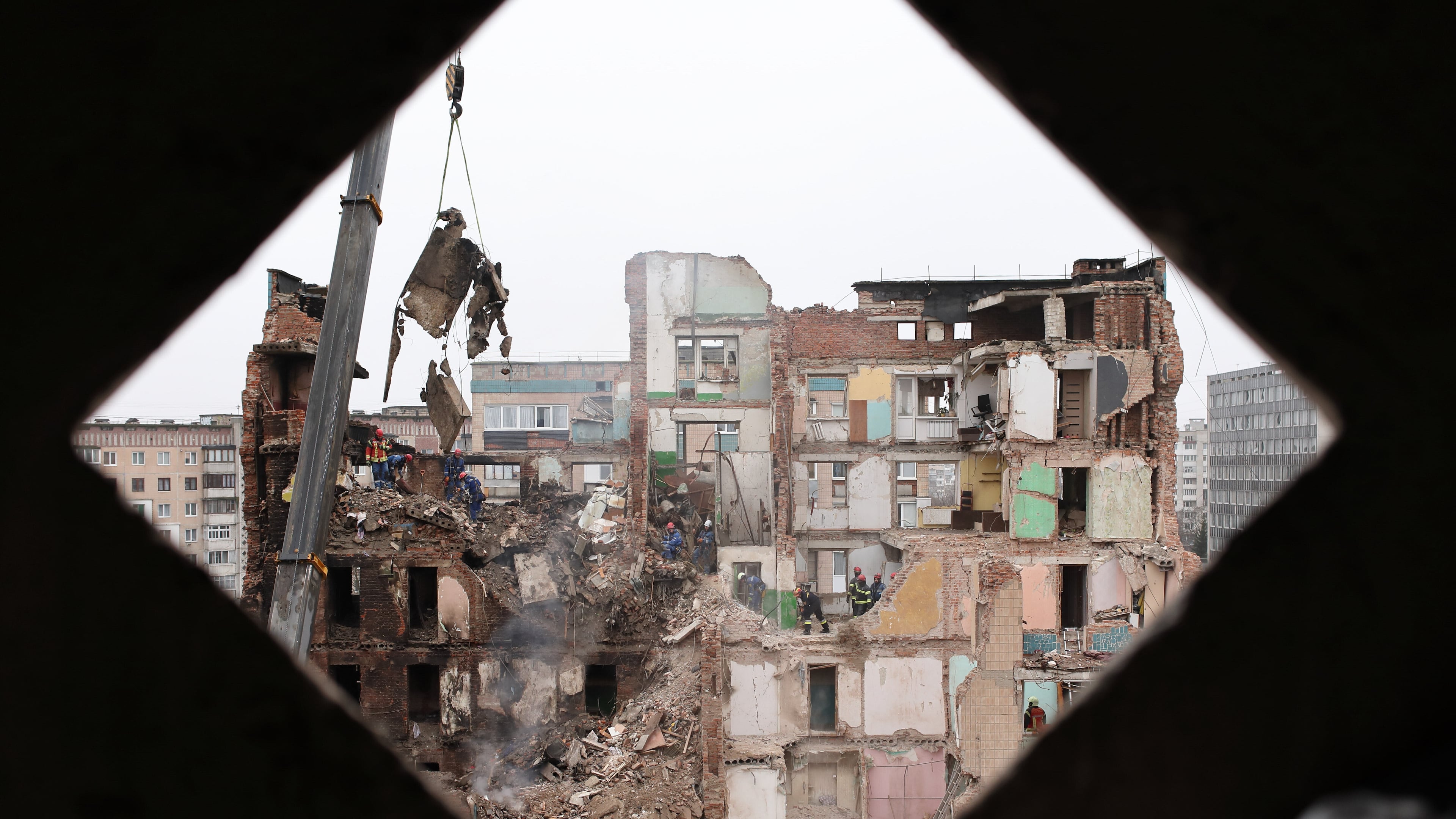 Rescue workers clear the rubble of a residential building which was heavily damaged by a Russian strike on Ternopil, Ukraine, Friday, Nov. 21, 2025. (AP Photo/Vlad Kravchuk)