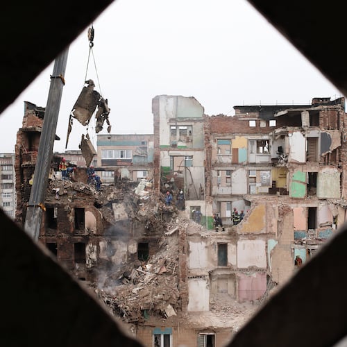 Rescue workers clear the rubble of a residential building which was heavily damaged by a Russian strike on Ternopil, Ukraine, Friday, Nov. 21, 2025. (AP Photo/Vlad Kravchuk)