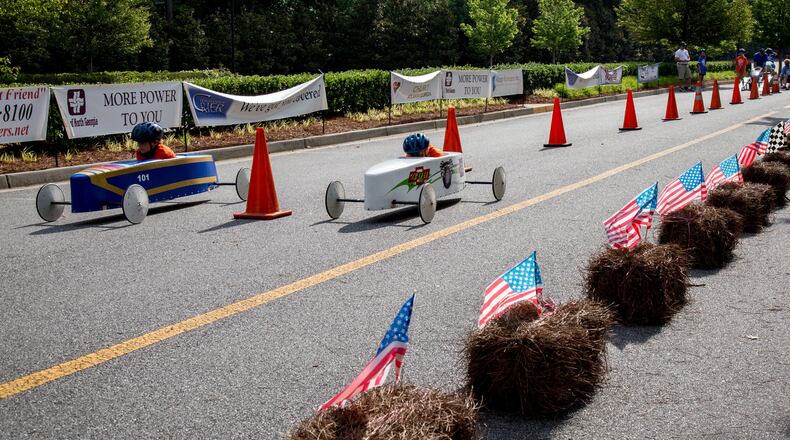 Two cars head for the finish line during a soapbox derby. A proposal to designate the Southeast Georgia Soap Box Derby in Lyons as the state’s official soapbox derby for tourism purposes moved forward Thursday when the Georgia House voted unanimously for it. The measure now heads to the state Senate. STEVE SCHAEFER / SPECIAL TO THE AJC