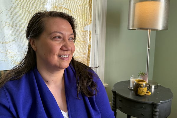 Siniva Bennett, board chair of the Samoa Pacific Development Corporation, sits in her home in Portland, Ore., Monday, May 19, 2025. (AP Photo/Claire Rush)
