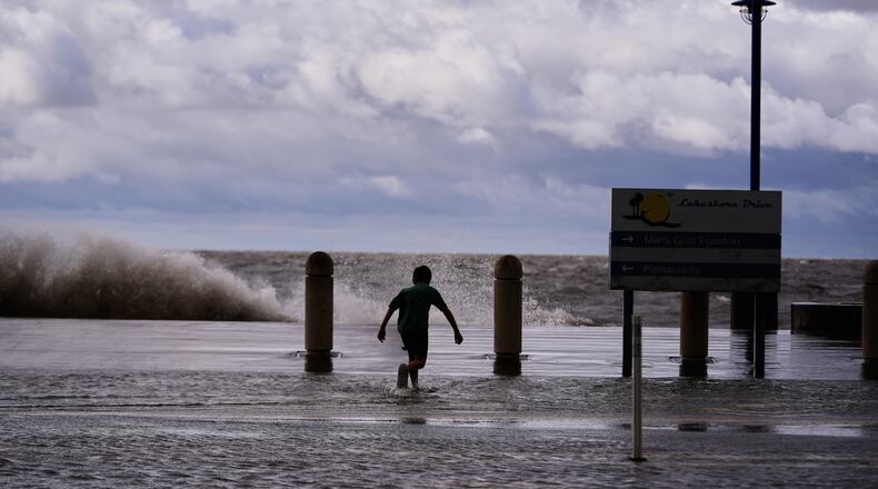 Josiah Carpenter, 8, frolics in the floodwaters on Lakeshore Drive along Lake Pontchartrain as Tropical Storm Bertha approaches the Louisiana Coast Wednesday, July 22, 2026, in New Orleans. (AP Photo/Gerald Herbert)